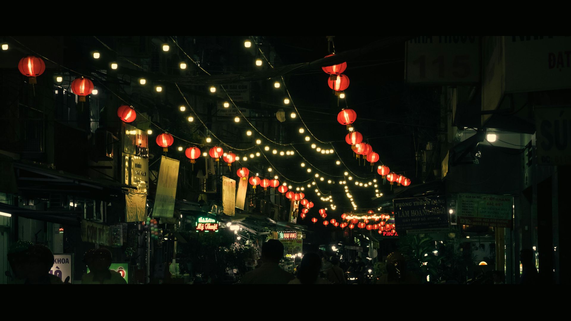 A bustling street decorated with festive lights and lanterns, with families strolling on a Ramadan evening.